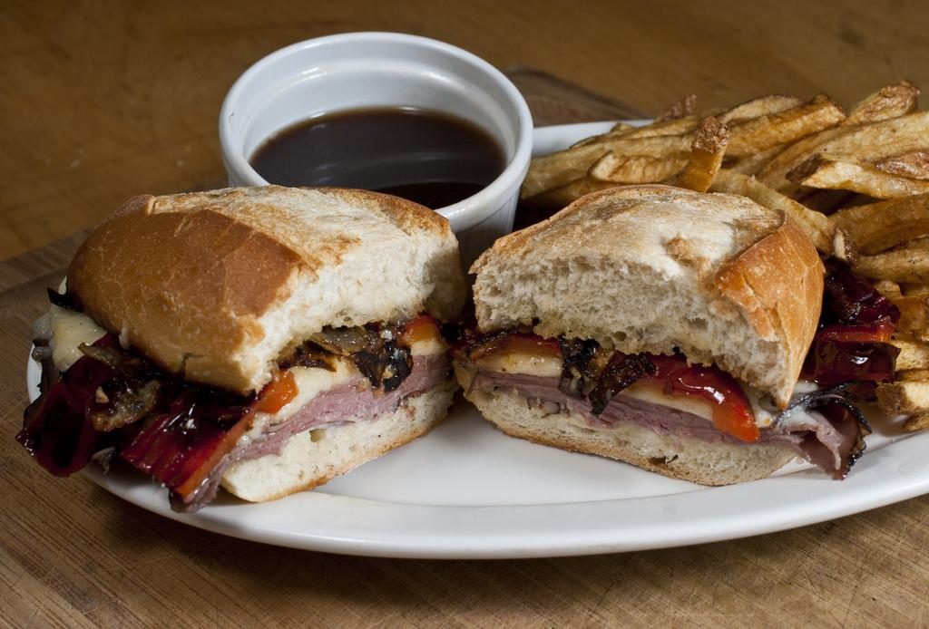 Hot Roast Beef Sandwich with Roasted Red Peppers, Sauteed Onions, Swiss Cheese, Garlic Aioli, and Au Jus for dippin’