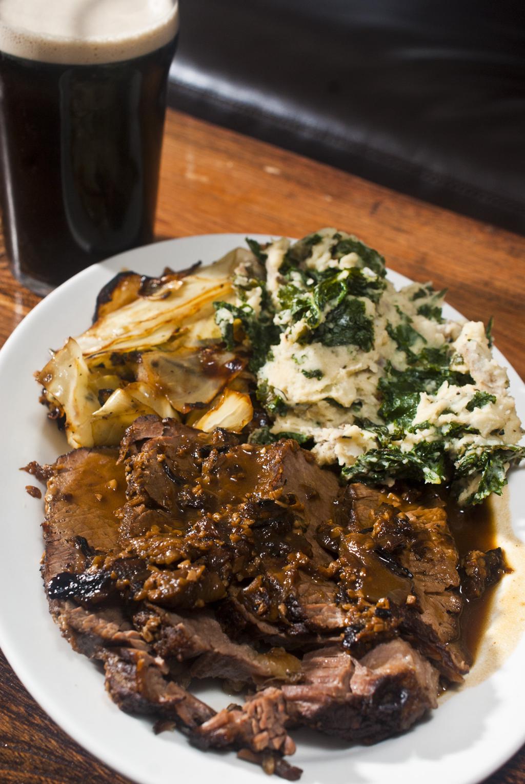 Guinness braised brisket au jus, sautéed cabbage and colcannon