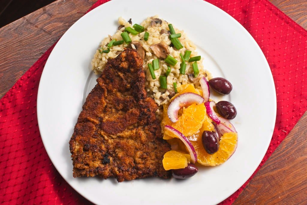 Cotoletta with mushroom risotto and orange salad