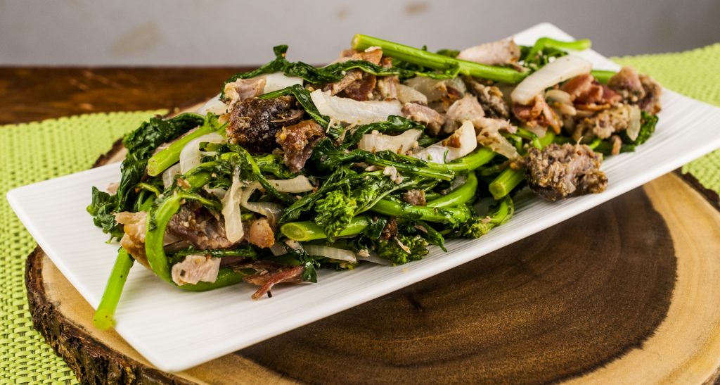 Warm Rapini Salad with bacon and porchetta in a dijon balsamic dressing