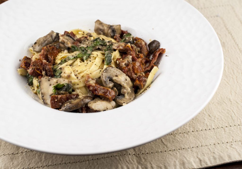 Fettuccine with mushrooms and sun dried tomatoes in cream sauce