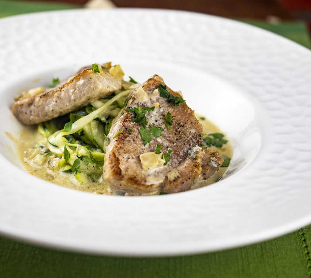 Pork medallions in blue cheese sauce served over zucchini noodles