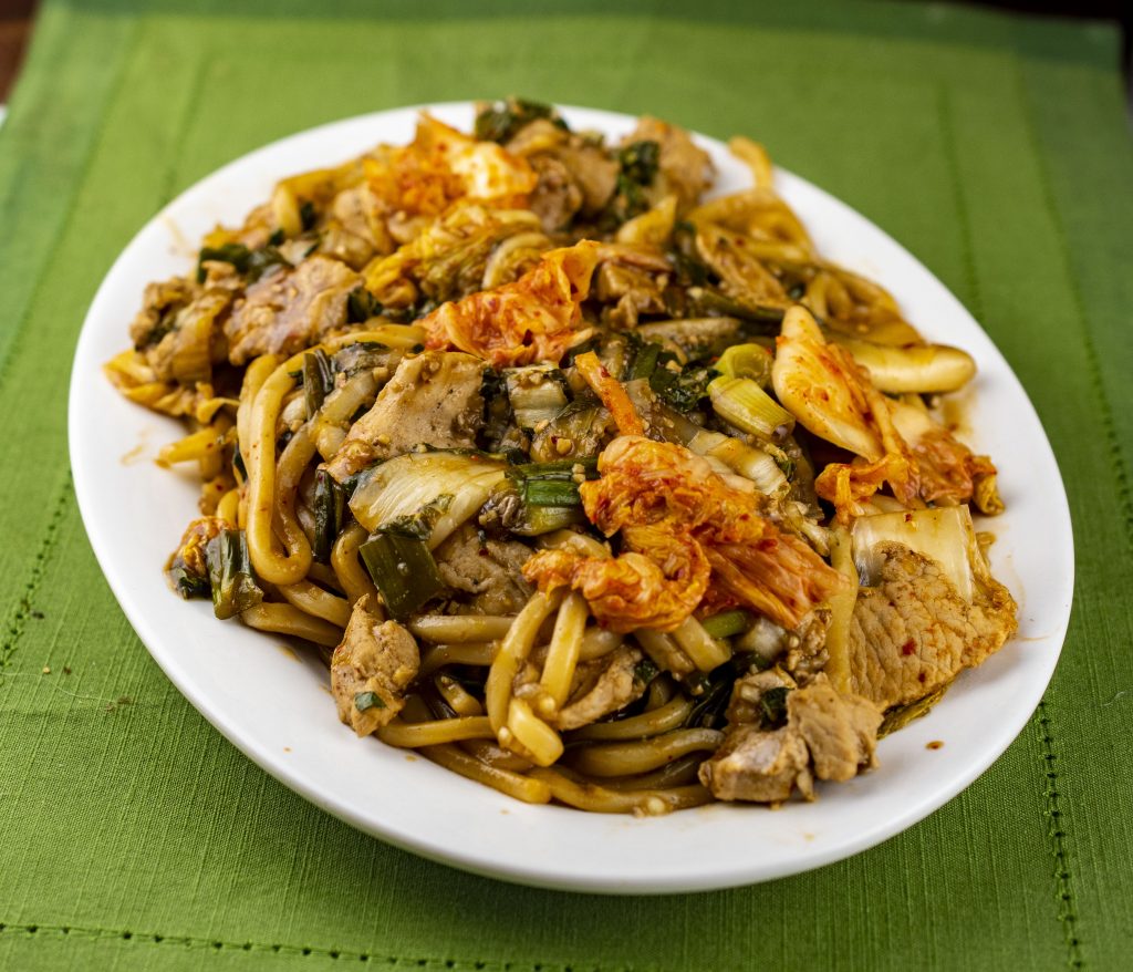 Udon noodles with shaved pork, bok choy and kimchi