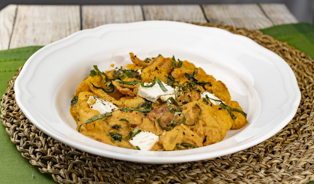 Gnocchi with bacon, goat cheese, spinach and sweet onions in sun dried tomato cream sauce